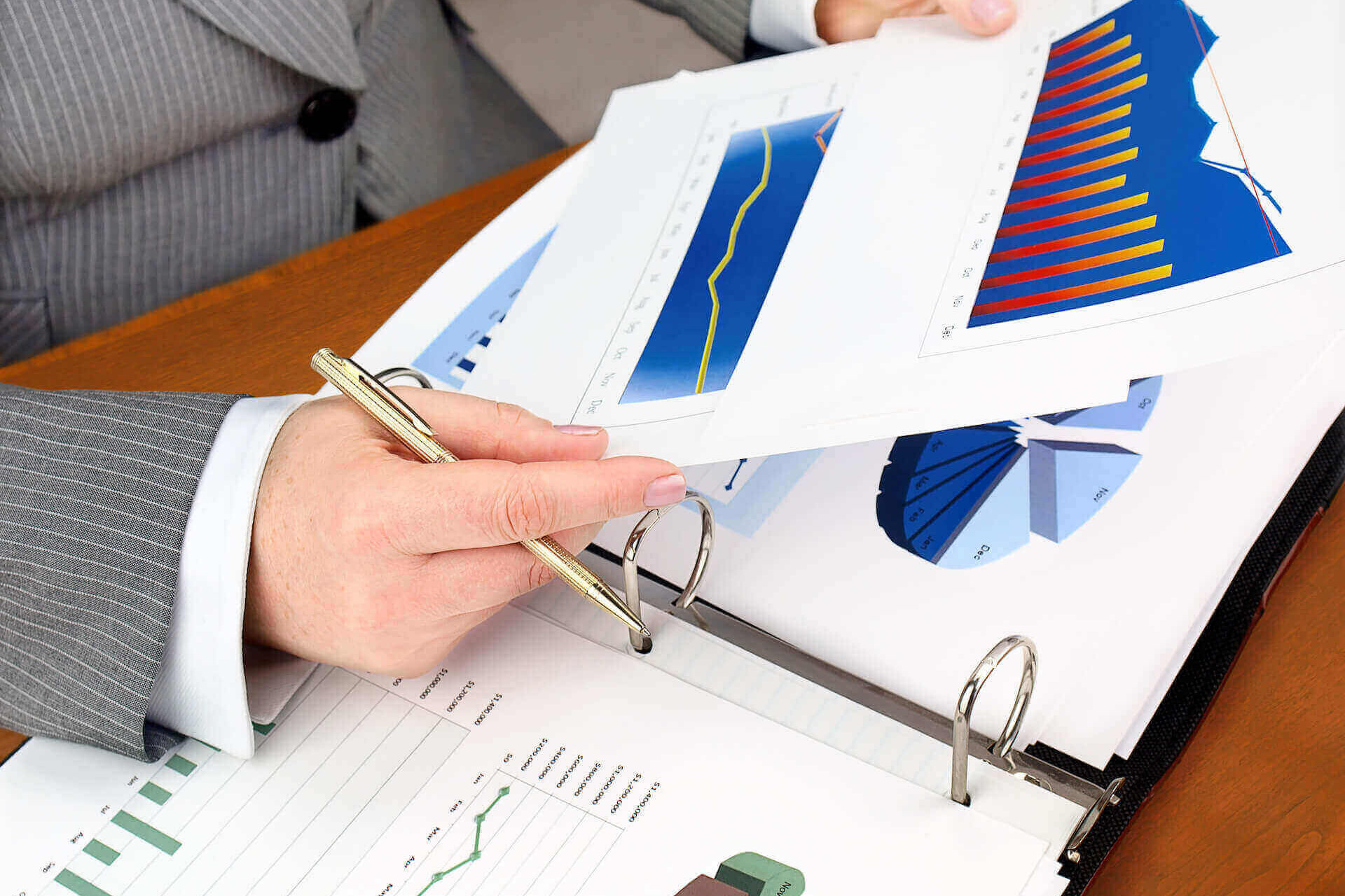 financial advisor looking at trends with a pen and papers